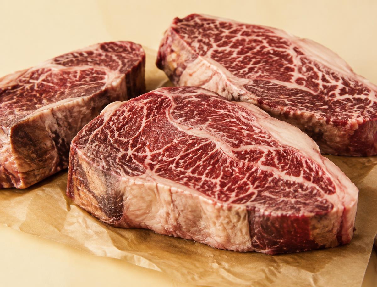 Marbled dry-aged steaks on parchment